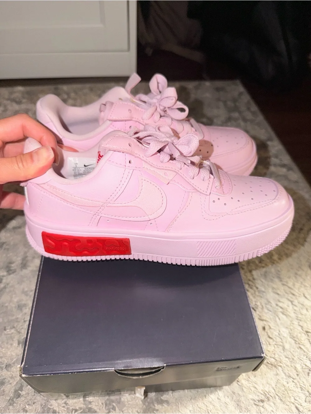 Nike Women’s Pink Sneakers with Red Heel Accent